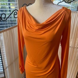 Orange women’s blouse with long sleeves.